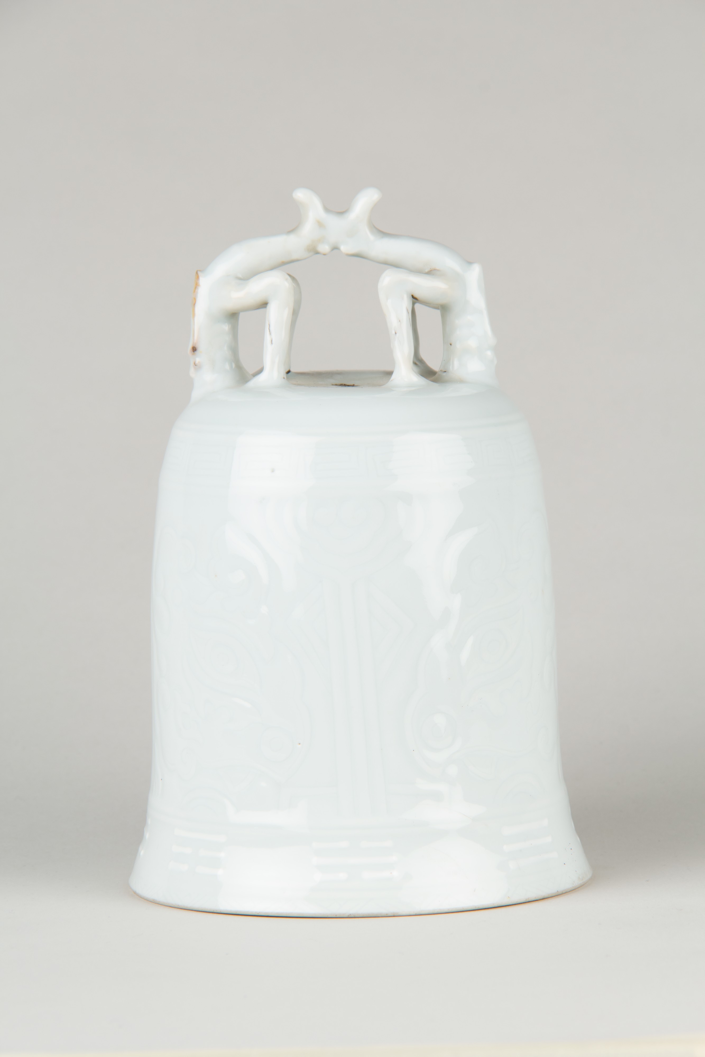 Bell, Porcelain with low-relief decoration under clear glaze, Dehua ware (blanc de chine), 18th century (Qianlong period), H. 17.1 cm, The Metropolitan Museum of Art, 79.2.502, Blanc de Chine